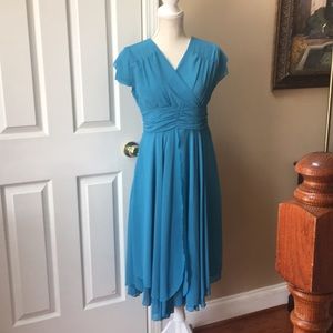 Peacock blue asymmetrical hemmed dress with layered skirt.